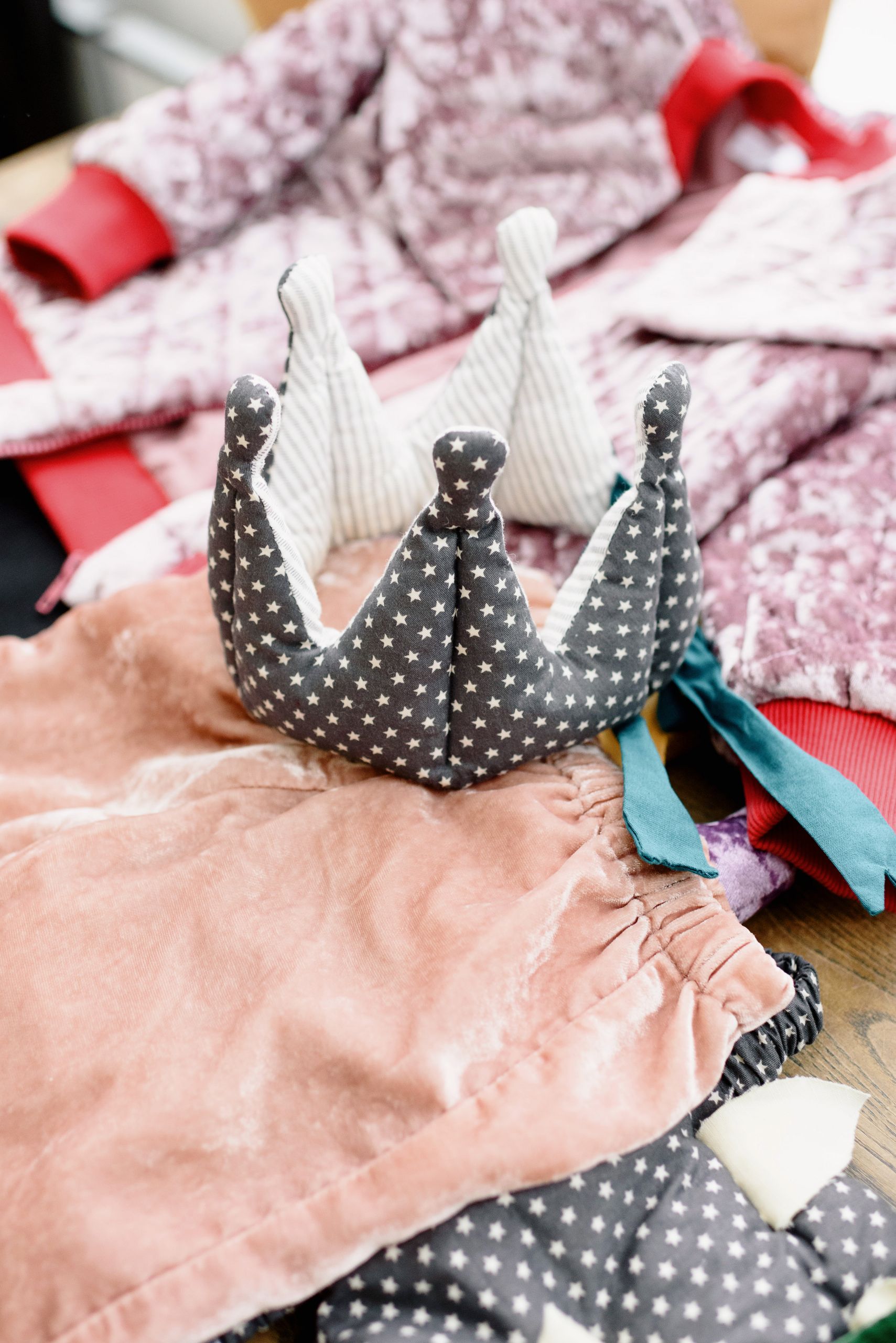 Explore playful children's fashion with a star-patterned crown and vibrant fabrics.